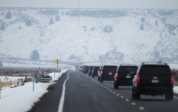 A large convoy of law enforcement vehicles drive toward the Malheur National Wildlife Refuge, where four anti-government protesters remain, about 30 miles south of Burns, Ore., on Thursday, Jan. 2 ...