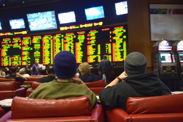 Gamblers sit in the sports book at Sunset Station casino in Henderson on Saturday, Jan. 31, 2015. Gamblers wagered over $100 million in 2014. (Jacob Kepler/Las Vegas Review-Journal)