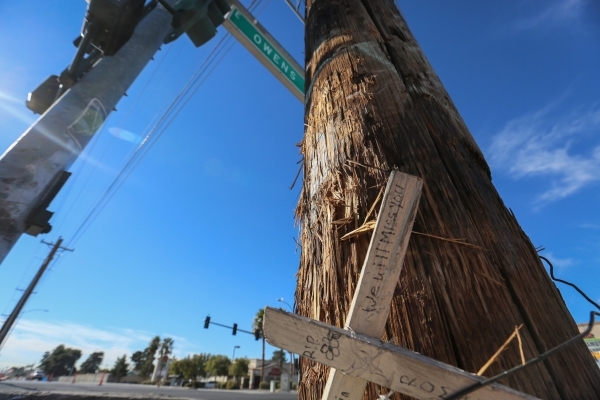A cross memorializing a woman who died in a fatal accident involving a utility pole in March of 2015 at the intersection of East Owens Avenue and North Pecos Road marks the spot where a 20-year-ol ...