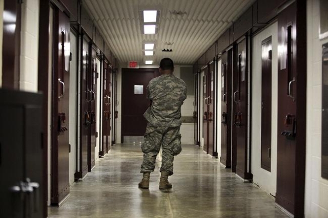 A U.S. military guard stands in a cell block at the Camp 5 detention facility at Guantanamo Bay U.S. Naval Base, Cuba in this May 31, 2009 file photo reviewed by the U.S. military. (Reuters/Brenna ...