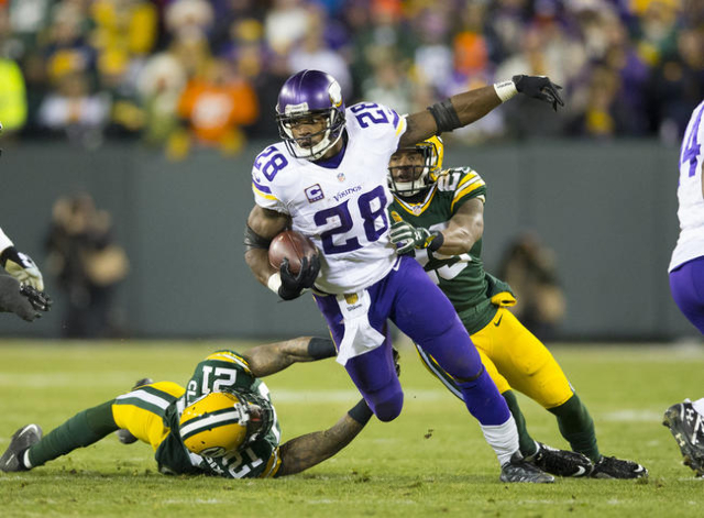 Jan 3, 2016; Green Bay, WI, USA; Minnesota Vikings running back Adrian Peterson (28) rushes with the football during the third quarter against the Green Bay Packers at Lambeau Field.  Minnesota wo ...