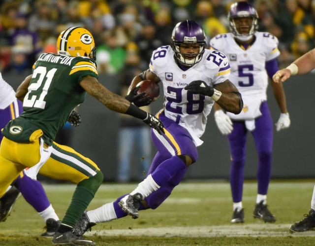 Jan 3, 2016; Green Bay, WI, USA; Minnesota Vikings running back Adrian Peterson (28) tries to run past Green Bay Packers safety Ha Ha Clinton-Dix (21) in the third quarter at Lambeau Field. (Benn ...