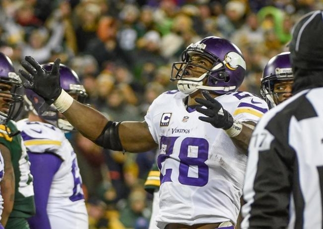 Jan 3, 2016; Green Bay, WI, USA;  Minnesota Vikings running back Adrian Peterson (28) reacts after scoring a touchdown in the third quarter during the game against the Green Bay Packers at Lambeau ...