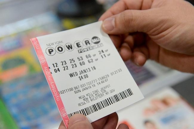 A person holds a Powerball ticket in New York January 10, 2016. (Reuters/Stephanie Keith)