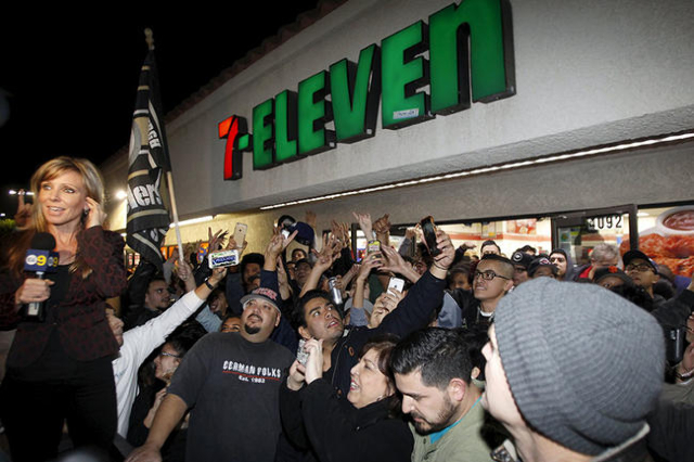 A crowd gathers in front of the 7-Eleven store where a winning Powerball ticket was sold, in Chino Hills, California January 13, 2016. A winning ticket was sold there for the massive $1.59 billion ...