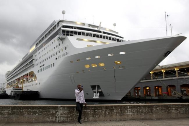 A man takes selfies in front of the passengers cruise ship MSC Opera in Havana in this January 13, 2016 picture. REUTERS/Alexandre Meneghini
