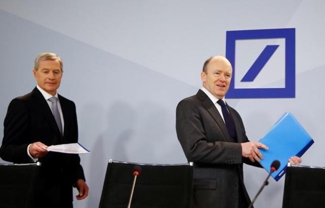 Deutsche Bank co-CEO Juergen Fitschen and Chief Executive John Cryan (R) arrive for a news conference in Frankfurt, Germany, January 28, 2016. (Kai Pfaffenbach/Reuters)