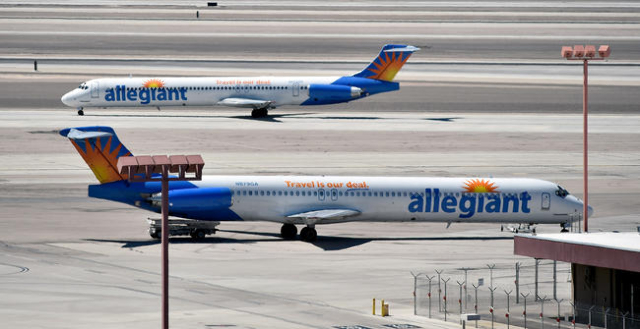 An Allegiant Air jet passes another jet at McCarran International Airport on Monday, April 27, 2015, in Las Vegas. (David Becker/Las Vegas Review-Journal)