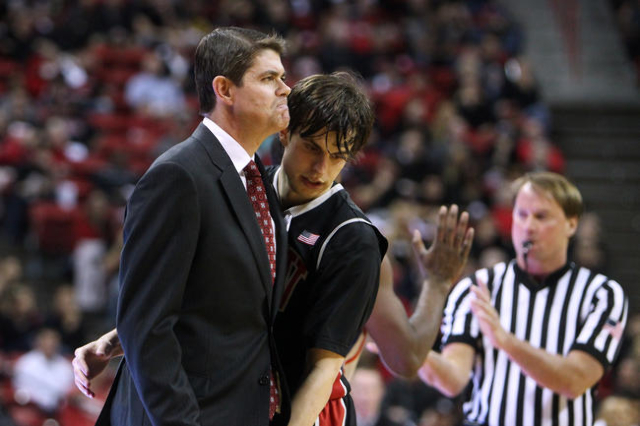 UNLV guard Cody Doolin bumps into a frowning head coach Dave Rice as they head to a timeout after a Boise State basket during the second half of their Mountain West Conference game Wednesday, Feb. ...