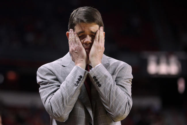 UNLV head coach Dave Rice covers his face in frustration after a Rebels turnover to Utah State during the second half of their Mountain West Conference game Saturday, Jan. 24, 2015, at the Thomas  ...
