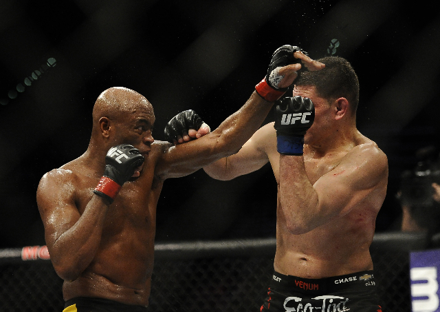 UFC middleweight Anderson Silva, left, fights with UFC middleweight Nick Diaz during their fight at UFC 183 at the MGM Grand Garden Arena in Las Vegas, Saturday, Jan. 31, 2015.(Josh Holmberg/Las V ...