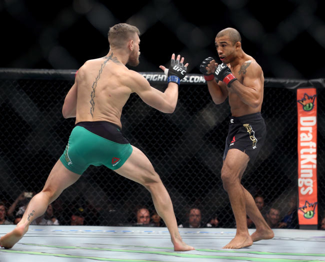 Conor McGregor, left, and Jose Aldo face each other down during a featherweight title bout at UFC 194 at the MGM Grand Garden Arena on Saturday, Dec. 12, 2015, in Las Vegas. McGregor won by a firs ...