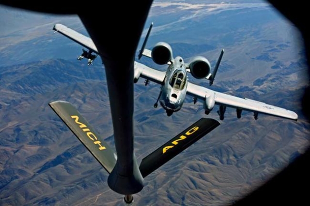 An A-10 Thunderbolt attack jet, affectionately known as the Warthogs, flies behind a Michigan Air National Guard KC-135T Stratotanker during a Green Flag exercise over the Mojave Desert near Fort  ...