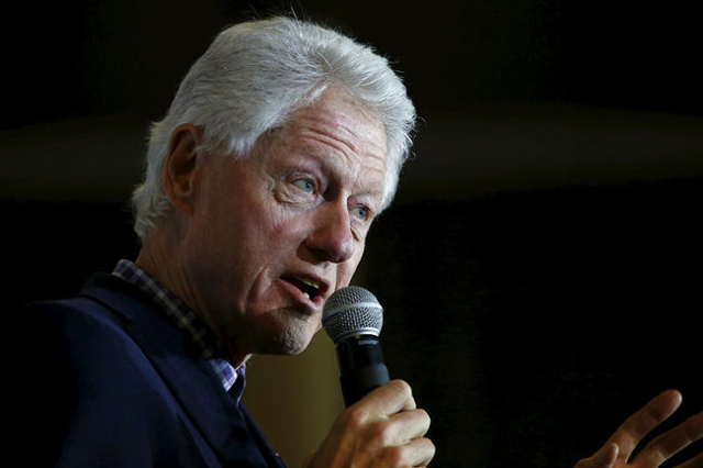 Former U.S. President Bill Clinton, accompanied by his daughter Chelsea, speaks at Abraham Lincoln High School while campaigning for his wife, U.S. Democratic presidential candidate Hillary Clinto ...