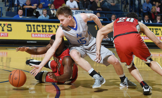 Air Force guard Jacob Van (center) scrambles for the ball with UNLV guard Ike Nwamu (left) and UNLV guard Austin Starr (right) during a game at the Air Force Academy on Tuesday, February 16, 2016. ...