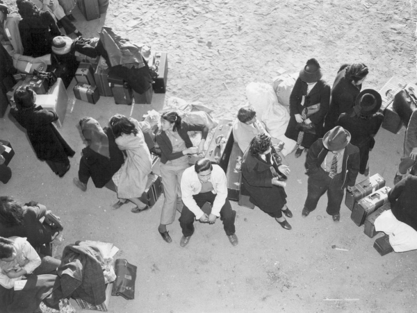 After arriving by train in Lone Pine, California, on April 1, 1942, Japanese-Americans wait for buses to take them to Manzanar, one of 10 relocation centers the government created after Japan&lsqu ...
