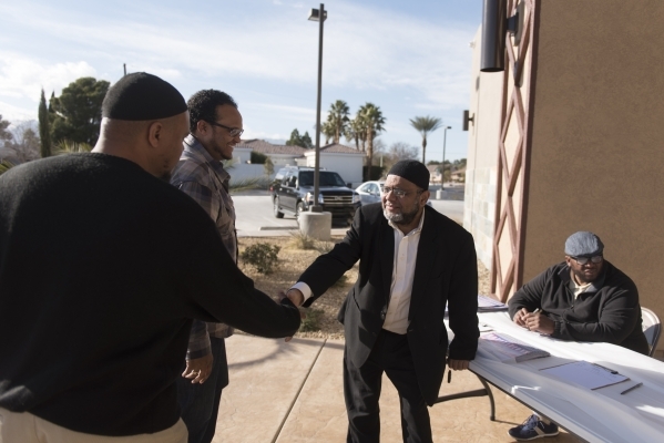 Dr. Aslam Abdullah, center, greets Faruq R. Dowdell, far left, and Kimani Kamau as they arrive for a neighborhood get together during Masjid Ibrahim‘s opening weekend in Las Vegas Saturday,  ...