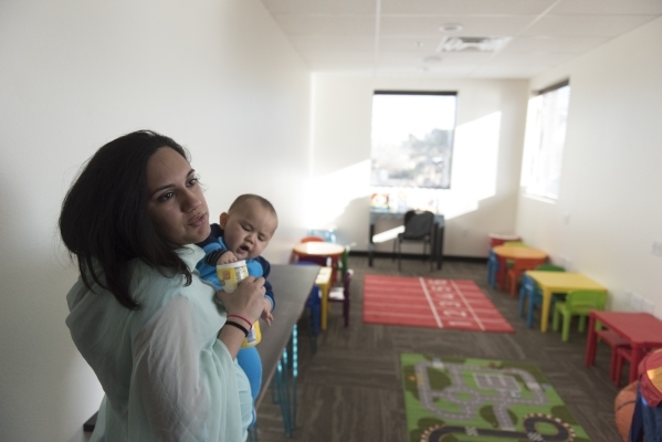 Saira Haseebullah speaks to a reporter as she holds her 10-month-old son Isaac Lee and gives a tour of Masjid Ibrahim during a neighborhood get together for the mosque‘s opening weekend in L ...