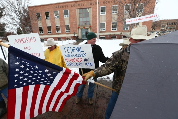 Local residents protest the shooting death of LaVoy Finicum, who was killed Tuesday night during an attempted arrest by FBI and Oregon State Police officers, outside of Harney County courthouse in ...