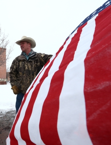 Local resident Mitch Siegner protests the shooting death of LaVoy Finicum, who was killed Tuesday night during an attempted arrest by FBI and Oregon State Police officers, outside of Harney County ...