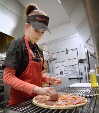 Team member Alexas Giese adds toppings to a pizza at Marco´s Pizza at 3400 S. Hualapai Way in Las Vegas on Thursday, Feb. 4, 2016. Bill Hughes/Las Vegas Review-Journal