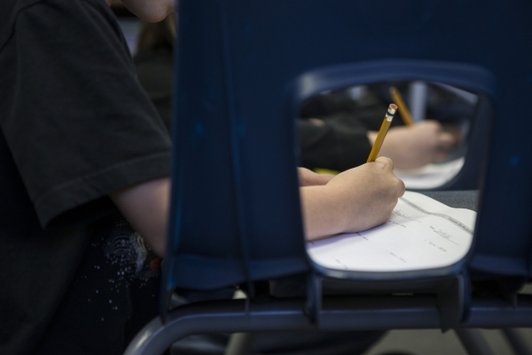 A student completes an assignment during class at Lomie Heard Elementary School classroom inside Nellis Air Force Base on Tuesday, Feb. 9, 2016, in Las Vegas. The school will close its doors at th ...