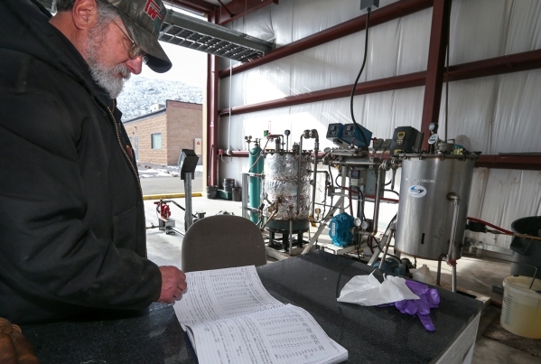 Chuck Bump, who heads research and development for Advanced Refining Concepts in the Tahoe-Reno Industrial Center near Sparks, Nev., looks through notes on tests of the refining process on Wednesd ...