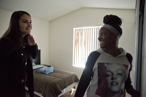 April Langstaff, right, and Banessa Gonzales walk through their rent-free apartment for the first time during a welcome home party, part of Olive Crest‘s Project Independence program at Saha ...