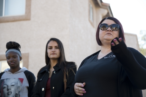 Olive Crest representative Amy Licht, right, speaks before Banessa Gonzales, center, and April Langstaff, left, receive a rent-free apartment as part of Olive Crest‘s Project Independence pr ...