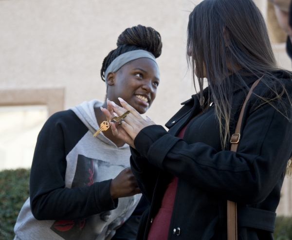 April Langstaff, left, and Banessa Gonzales react after receiving keys to a rent-free apartment as part of Olive Crest‘s Project Independence program during a Welcome Home Party at Sahara We ...