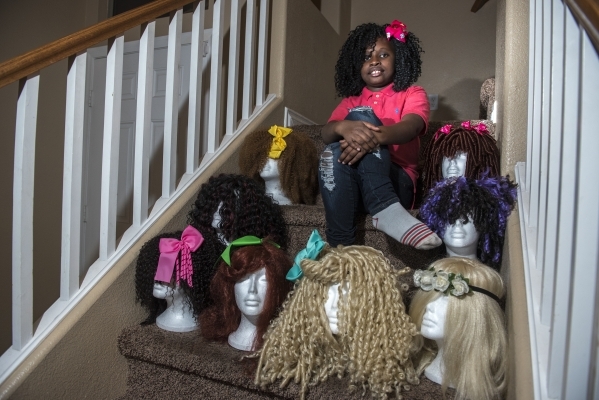 Lauren LaRay Collins, 8, poses with the wigs she makes for women who have lost their hair during treatment for cancer from her home in North Las Vegas on Tuesday, Feb. 9, 2016. Martin S. Fuentes/L ...