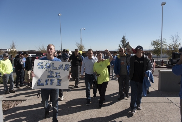 Solar workers and supporters prepare to march into the Public Utilities Commission office during a hearing at 9075 W. Diablo Dr. in Las Vegas Monday, Feb. 8, 2016. The protesters brought three whe ...