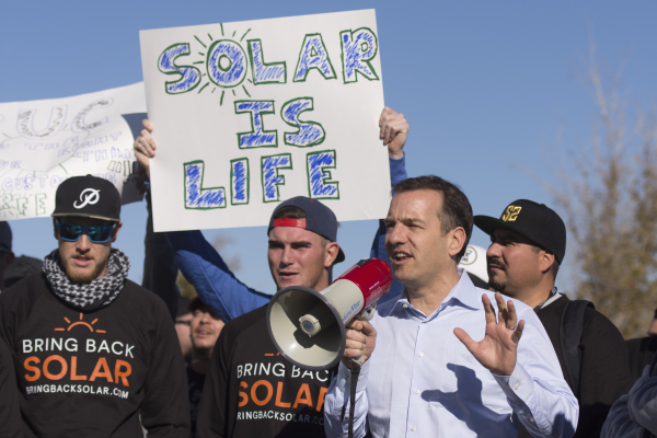 SolarCity Senior Vice President Marco Krapels, second from right, speaks to solar workers and supporters  protesting outside of the Public Utilities Commission office at 9075 W. Diablo Dr. in Las  ...