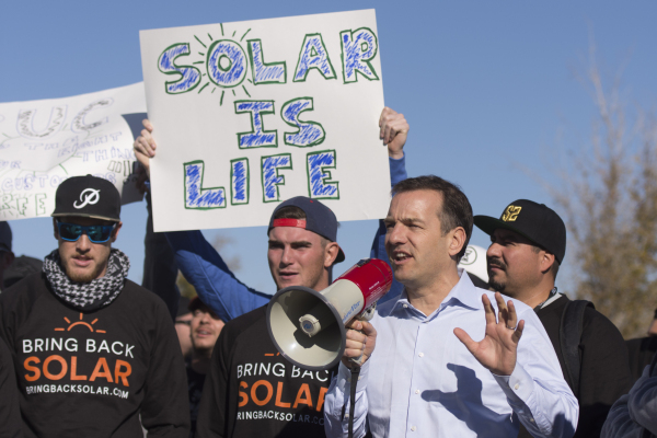 SolarCity Senior Vice President Marco Krapels, second from right, speaks to solar workers and supporters protesting outside of the Public Utilities Commission office at 9075 W. Diablo Dr. in Las ...