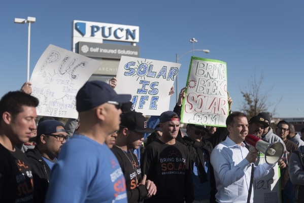 SolarCity Senior Vice President Marco Krapels, right, speaks to solar workers and supporters protesting outside of the Public Utilities Commission office at 9075 W. Diablo Dr. in Las Vegas Monday, ...