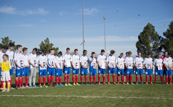 Team LA 59-62 from France holds signs spelling out "We pray for Nohemi" honoring Nohemi Gonzalez, who was killed in the recent terrorist attacks in Paris, on the field during opening cer ...