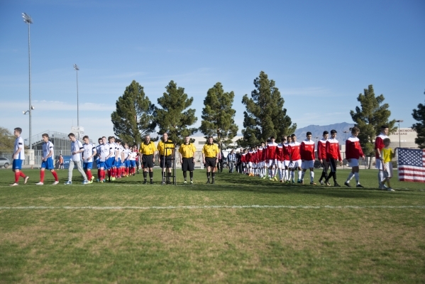 The Sagebrush Soccer Club United Red 98 from Reno, right, and Team LA 59-62 from France walk onto the field during opening ceremonies for the Las Vegas MayorþÃôs Cup International Showcas ...