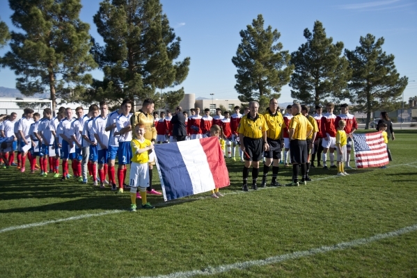 The Sagebrush Soccer Club United Red 98 from Reno, right, and Team LA 59-62 from France walk onto the field during opening ceremonies for the Las Vegas MayorÃ¾ÃÃ´s Cup International Showcas ...