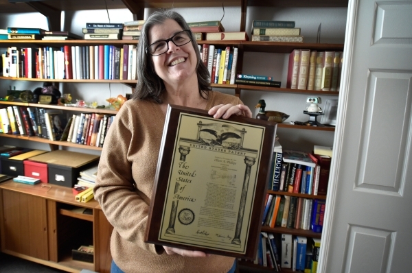 Laura Demetriades displays her father‘s patent certificate at his Henderson home Tuesday, Feb. 9, 2016. Phillips, 85, died in January from injuries from a beating in his home by a paid escor ...