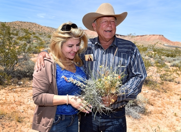 Nevada Assemblywoman Michele Fiore, left, accepts a bouquet of desert foliage from rancher Cliven Bundy during a news conference at an event near his ranch in Bunkerville on Saturday, April 11, 20 ...