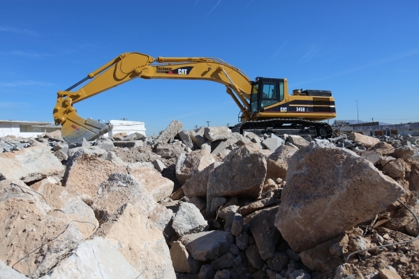 An excavator sits on top of rubble being trucked to the site of the Moulin Rouge in Las Vegas on Friday, Feb. 12, 2016. The rubble will be crushed into gravel for the site. Brett Le Blanc/Las Vega ...