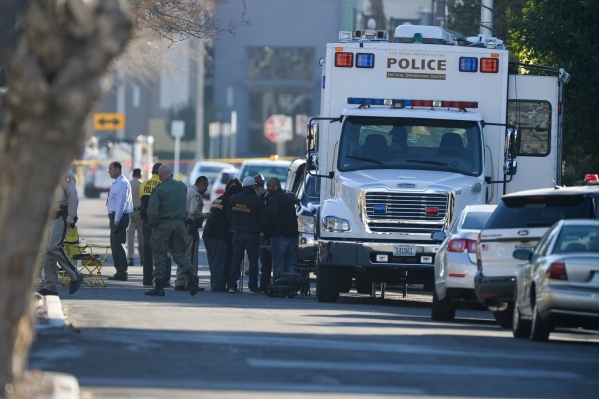 Police gather on Dumont Boulevard during a barricade situation in Las Vegas on Friday, Feb. 12, 2016. A police dog named Nicky was stabbed during the apprehension of the suspect. Brett Le Blanc/La ...