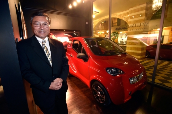 Michael Hu, president and CEO of 2050 Motors stands with his e-Go prototype, an all electric and carbon fiber body automobile at the William Carr Gallery at Tivoli Village Friday, Feb. 12, 2016, i ...