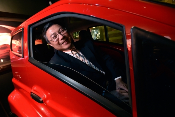 Michael Hu, president and CEO of 2050 Motors peers out the window of his e-Go prototype, an all electric and carbon fiber body automobile at the William Carr Gallery at Tivoli Village Friday, Feb. ...