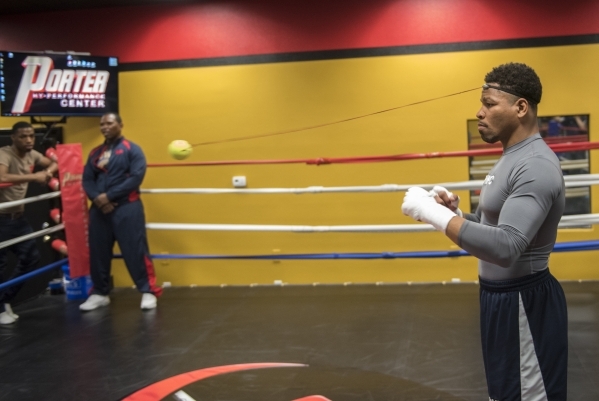 Professional boxer and former IBF welterweight champion "Showtime" Shawn Porter, right, is seen punching a tennis ball for hand eye coordination training at his gym, the Porter Hy-Perfor ...