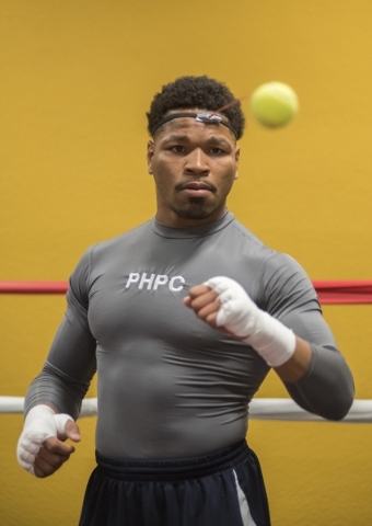 Professional boxer and former IBF welterweight champion "Showtime" Shawn Porter is seen punching a tennis ball for hand-eye coordination training at his gym, the Porter Hy-Performance ce ...