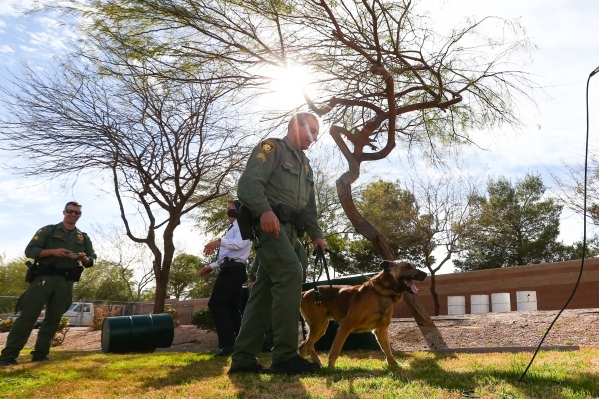 Las Vegas police Sgt. Eric Kerns walks with his partner, K9 officer Nicky, who was attacked by a suspect with a machete on Friday, at South Central Area Command in Las Vegas on Wednesday, Feb. 17, ...