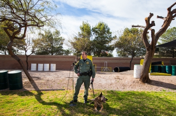 Las Vegas police Sgt. Eric Kerns, speaks with reporters alongside his partner, K9 officer Nicky, who was attacked by a suspect with a machete on Friday, at South Central Area Command in Las Vegas ...