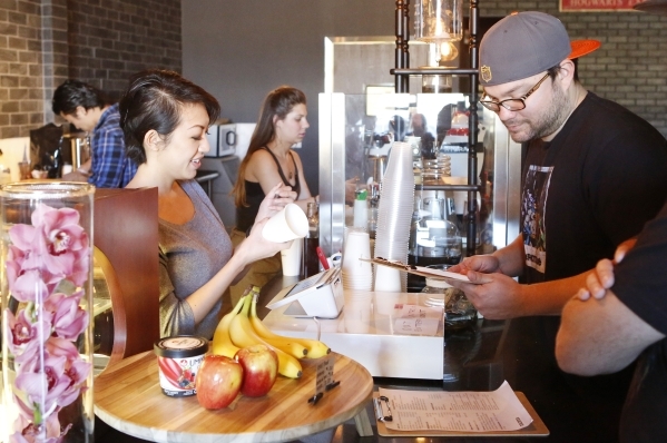 Annie Cheng, owner of Bad Owl Coffee on 10575 S. Eastern Ave., in Henderson, left, takes order from Jeff Ebarb of Henderson Friday, Feb. 19, 2016. Bad Owl Coffee had its grand opening Feb. 13 and  ...