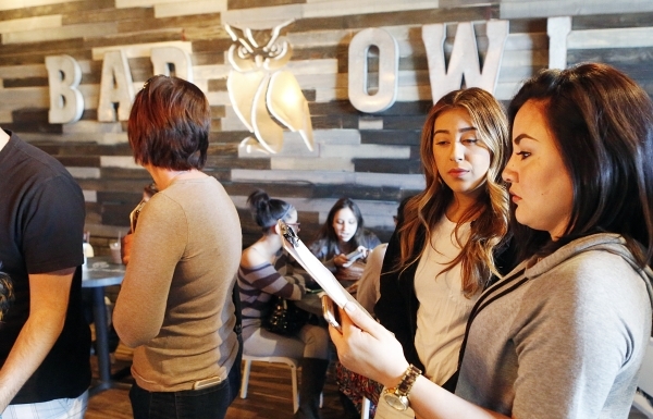 Caudia Robio, right, and Bianca Solis, both of Henderson, check out the menu as they stay in line at Bad Owl Coffee on 10575 S. Eastern Ave., in Henderson, Friday, Feb. 19, 2016. Bad Owl Coffee ha ...